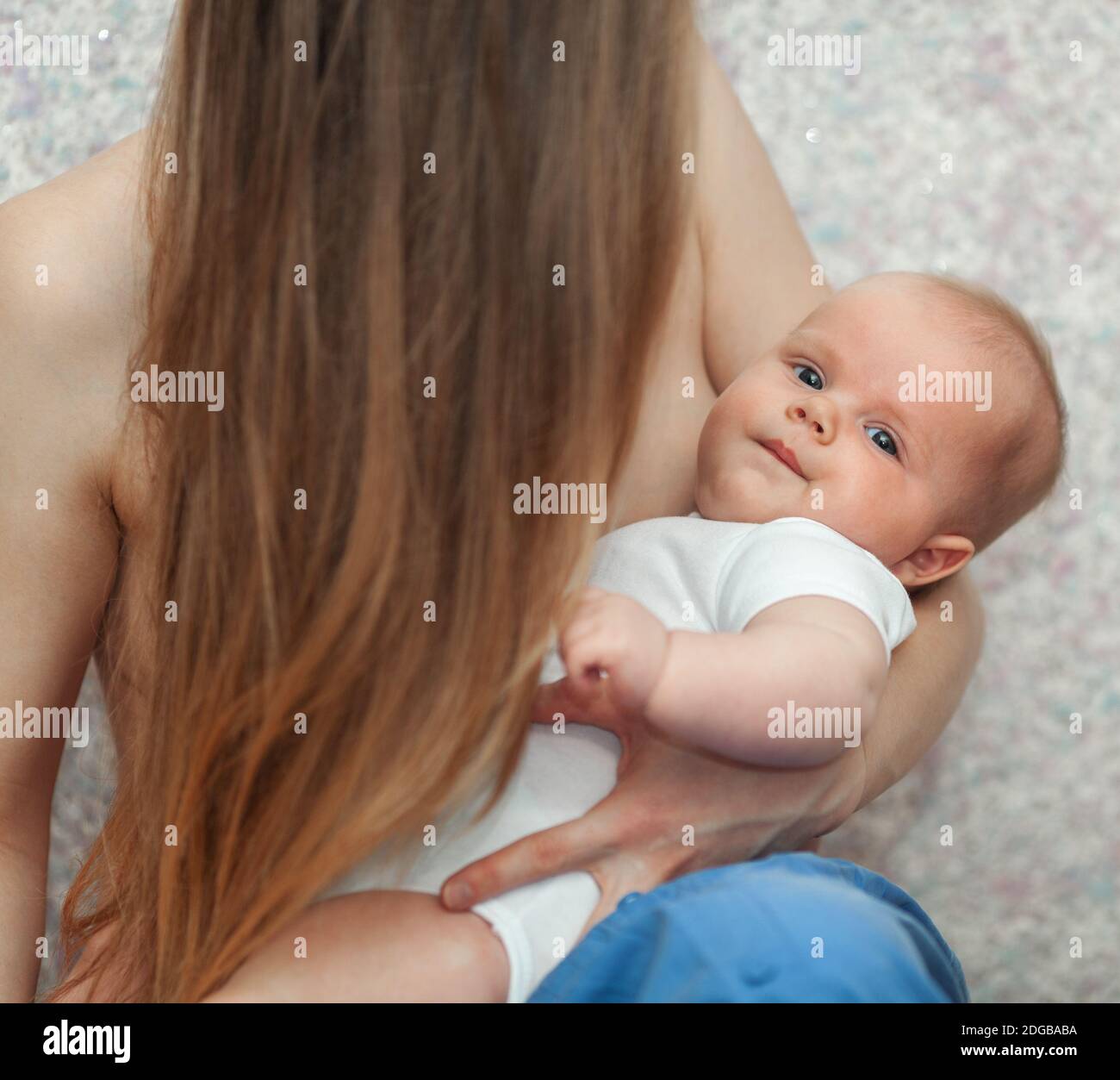 Baby in hands of loving and caring mother Stock Photo