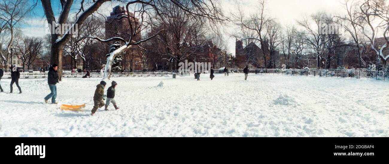 People walking in a snow covered park, Lower East Side, Manhattan, New York City, New York State, USA Stock Photo