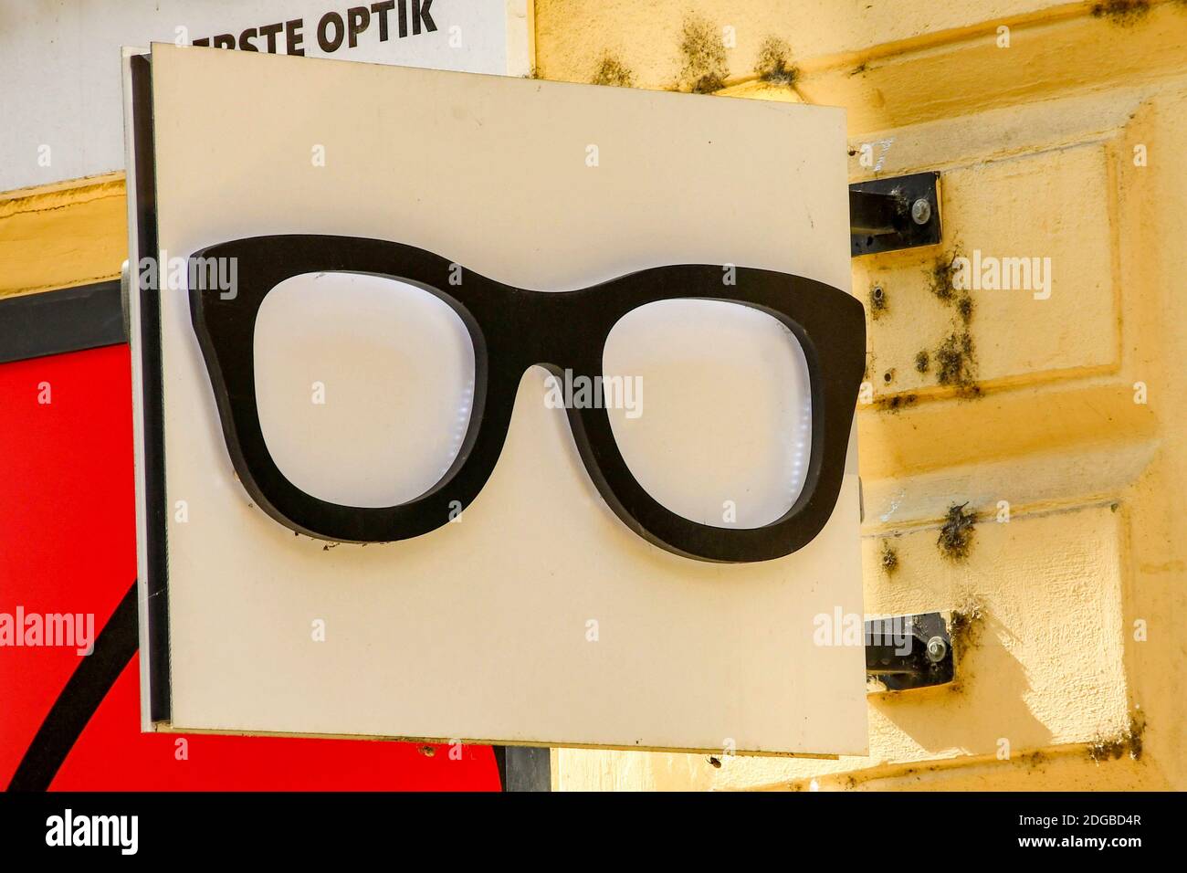 PRAGUE, CZECH REPUBLIC - JULY 2018: Large pair of glasses frames on a sign hanging outside an optician's shop in Prague Stock Photo
