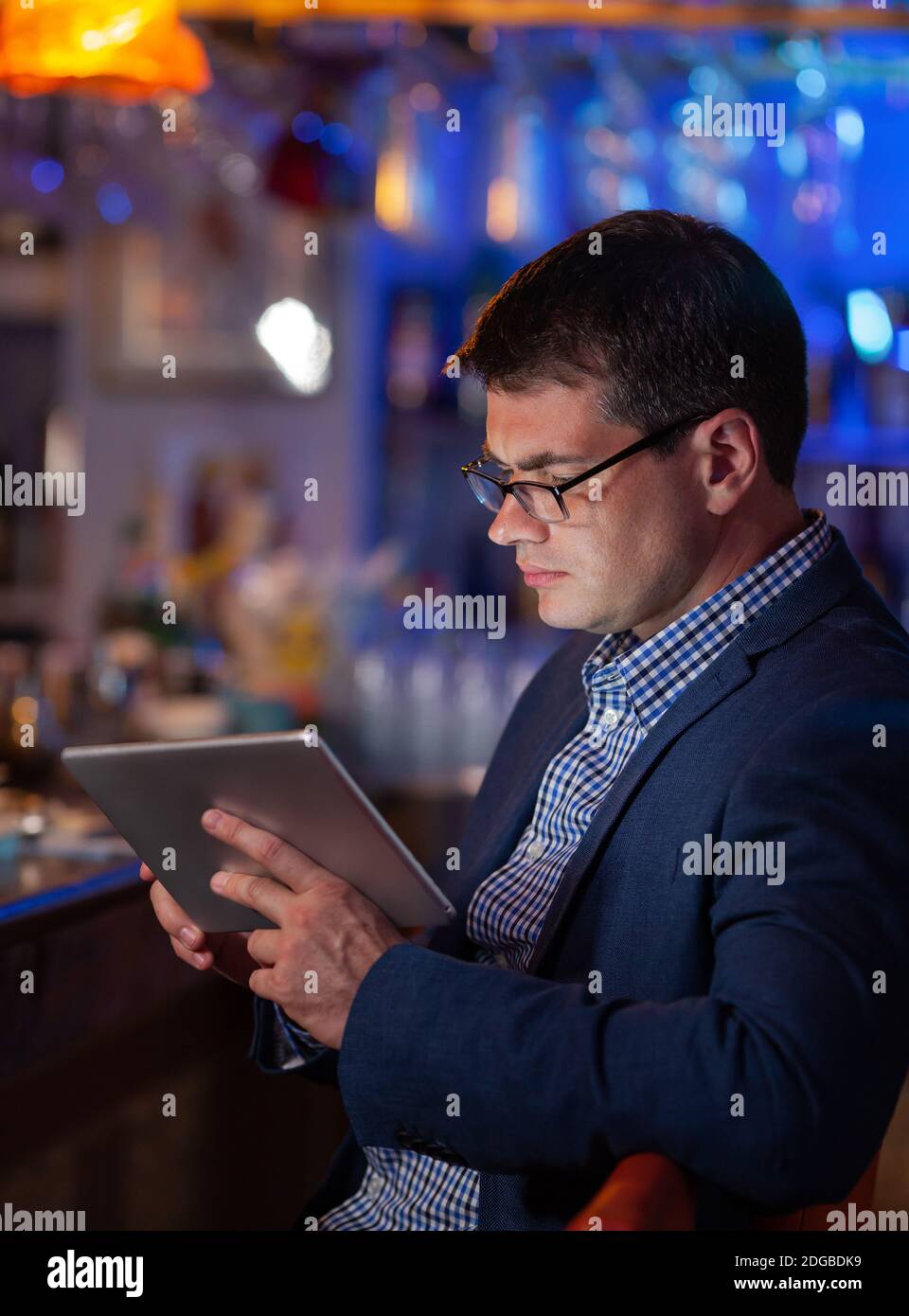 He cannot get away from his job even in the bar Stock Photo