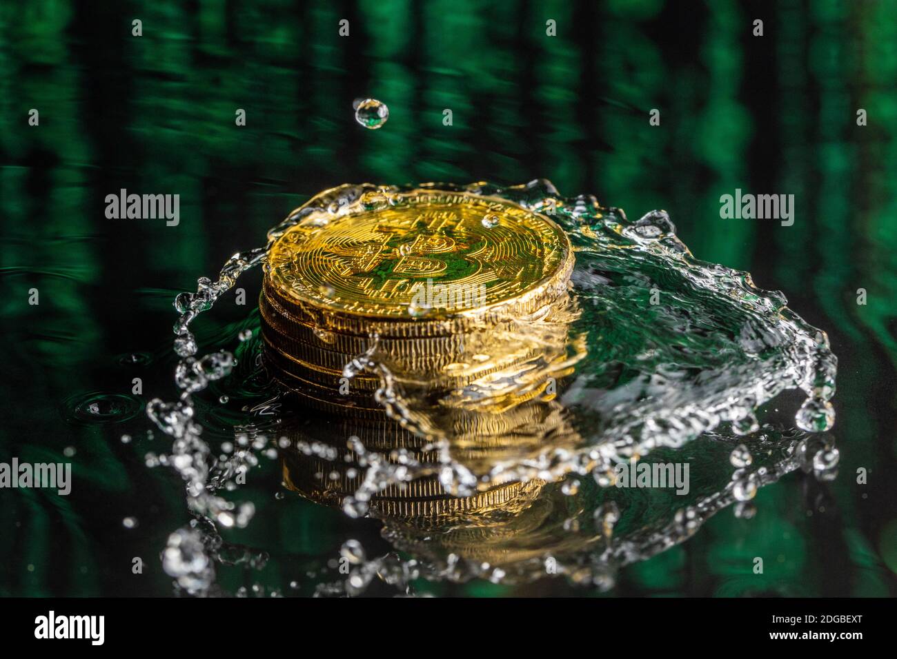 Gold bitcoin coin falling to water. Bitcoin and water splash. Stock Photo