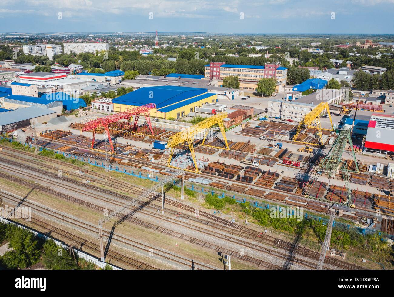 Industrial zone with warehouses and railroad cranes working on loading