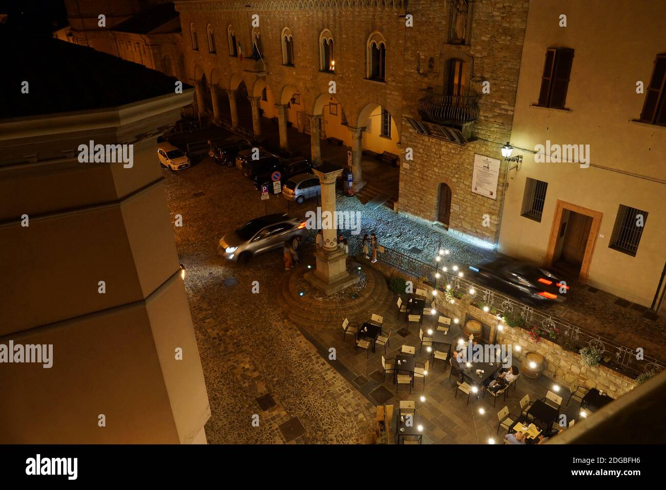 Restaurant on the street on a summer evening. People sit at tables on the street. Lantern light. Bertinoro, Forlì-Cesena, Emilia-Romagna, Italy. Stock Photo