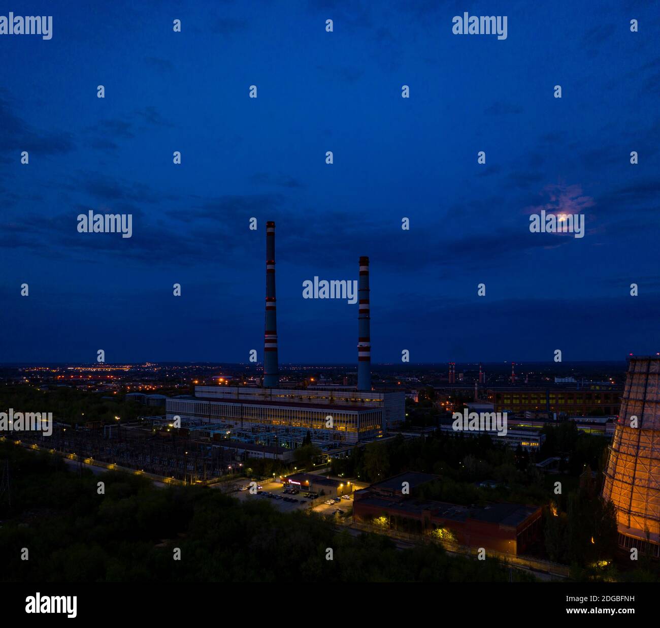 Big tubes of electro station industry building at night, aerial view Stock Photo
