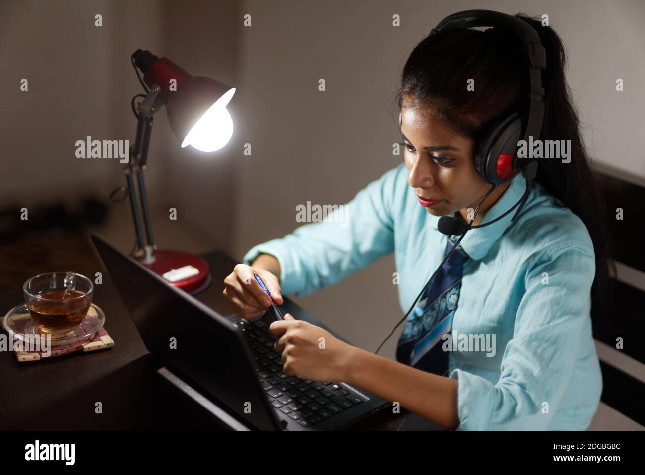 An Indian Bengali young woman/telecaller in office wear is