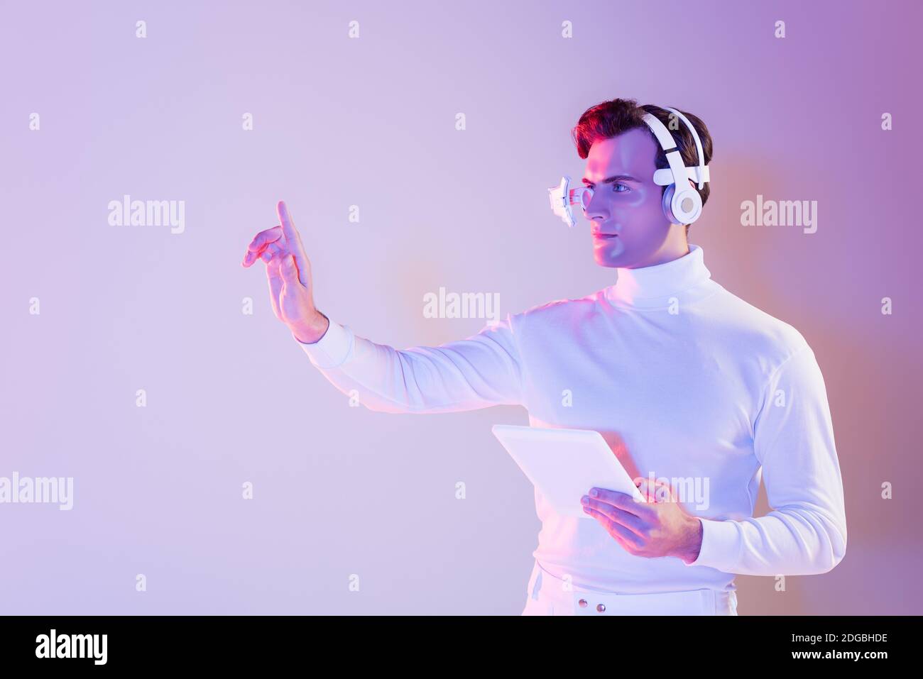 Cyborg in headphones holding digital tablet and using something on ...