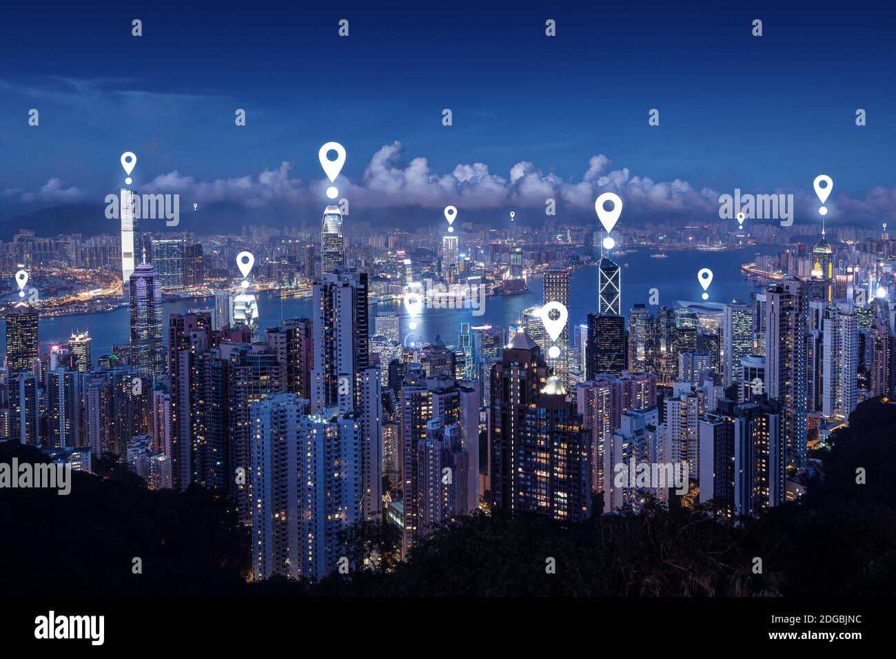 Map pin icons on cityscape of Hong Kong at dusk. Scenic view of Hong Kong's famous skyline from the Victoria Peak at night. Blue tone. Stock Photo