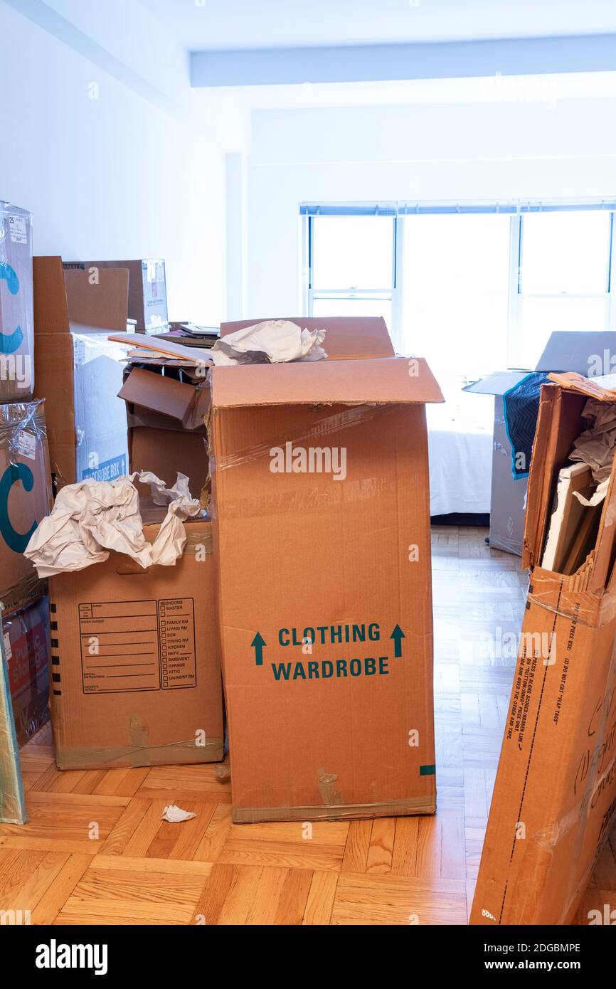 Stacks of cardboard moving boxes overwhelm a small New York City