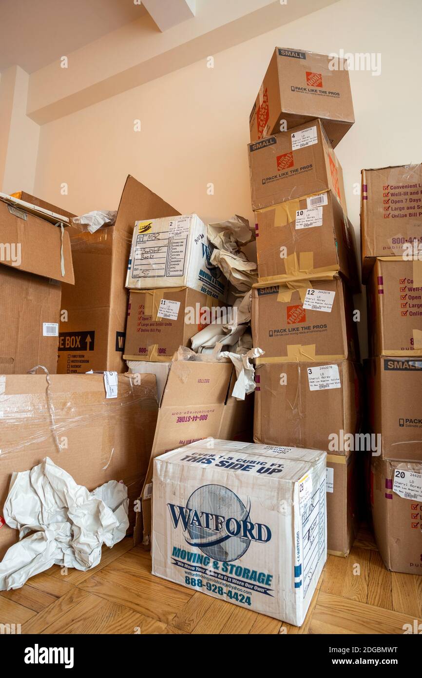 Stacks of cardboard moving boxes overwhelm a small New York City apartment, USA Stock Photo