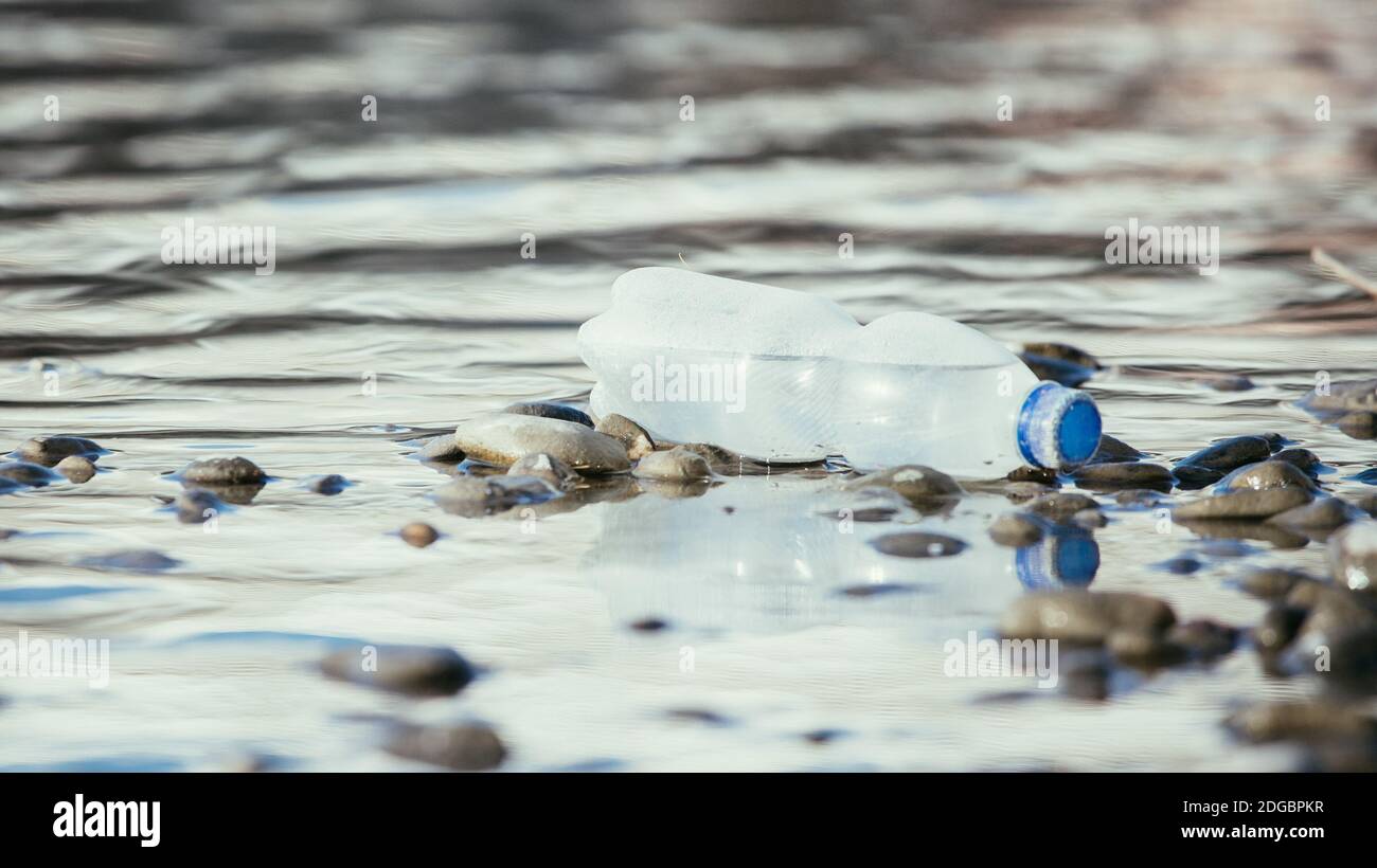 Environmental pollution: plastic bottle on the beach Stock Photo