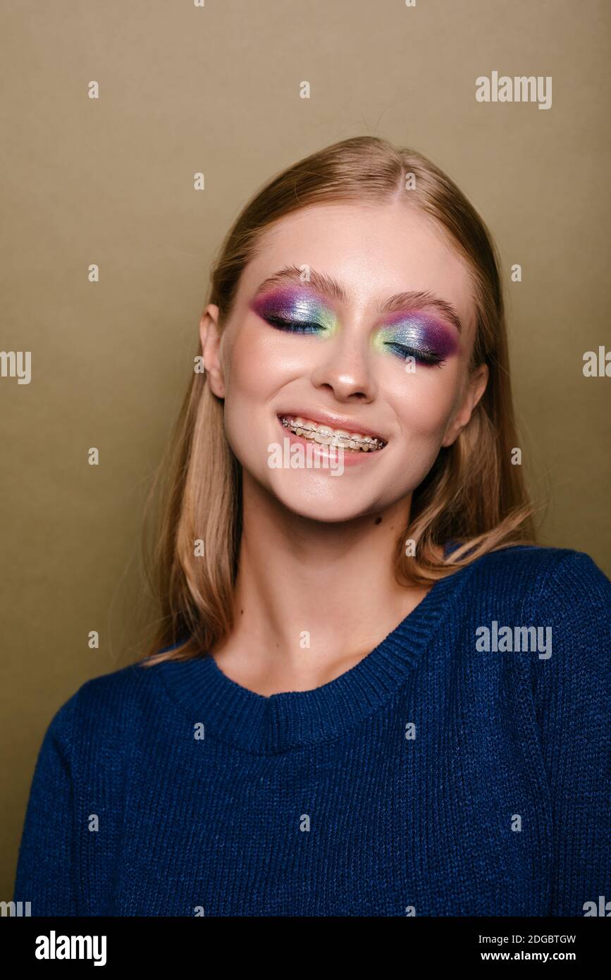 Portrait of a beautiful smiling woman with dental braces on her teeth ...