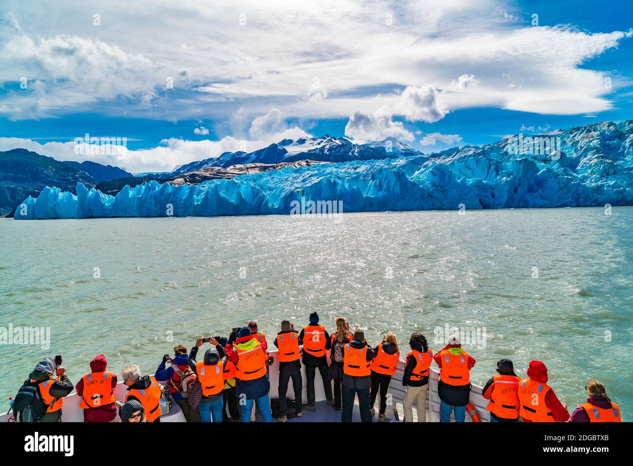 Tourists with orange color life jackets on a sightseeing boat excursion to the Grey Glacier Stock Photo