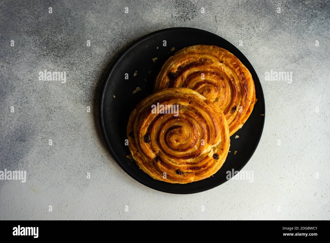 Overhead view of a two pain aux raisins on a plate Stock Photo