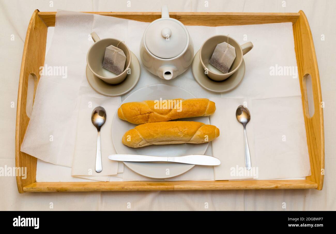 Tea set with hot tea and breakfast on a white wooden mat on the table Stock  Photo by ©belchonock 102145306