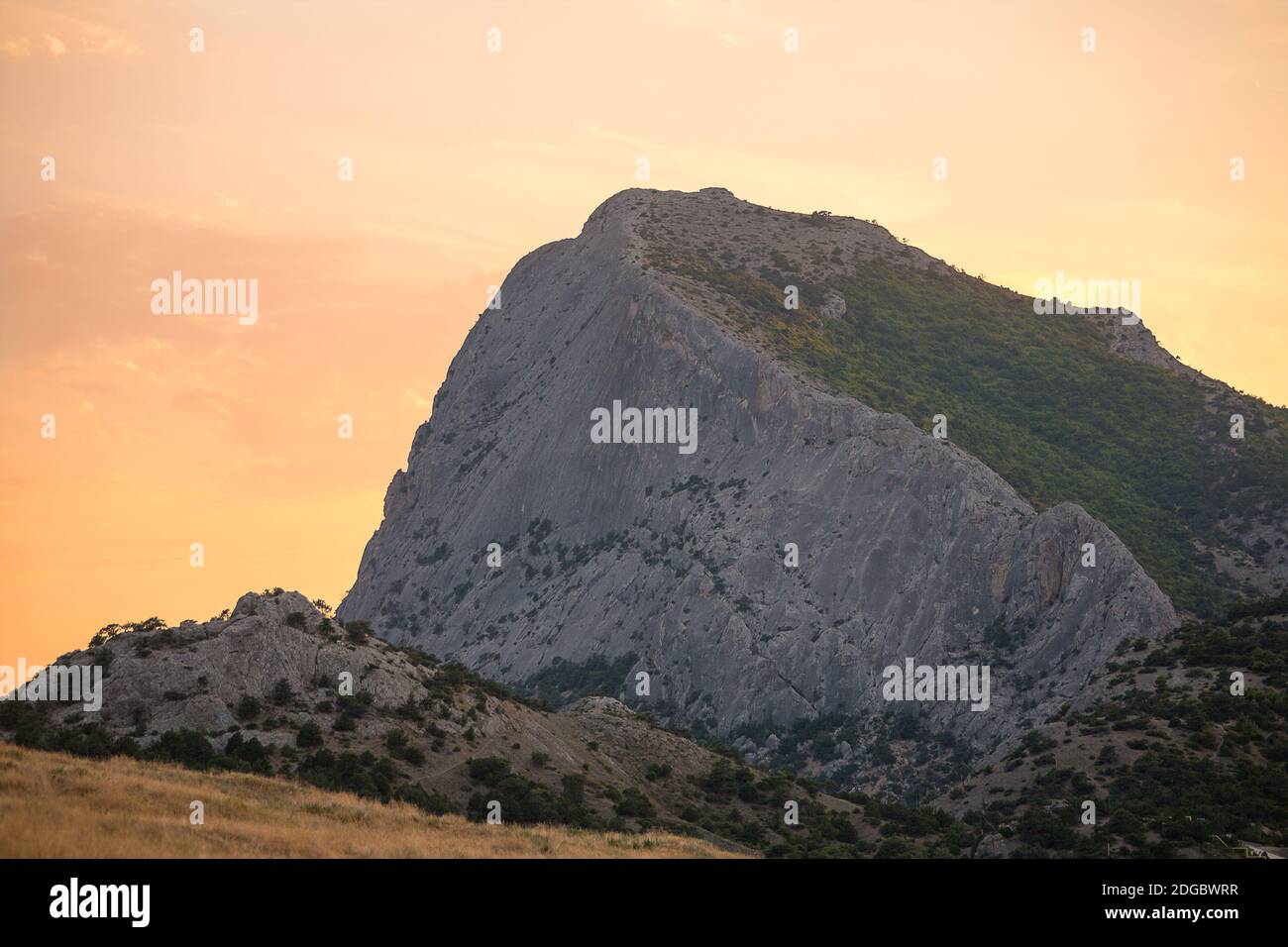 Highest mountain with steep slope at dawn or sunset light pale pink sky Stock Photo