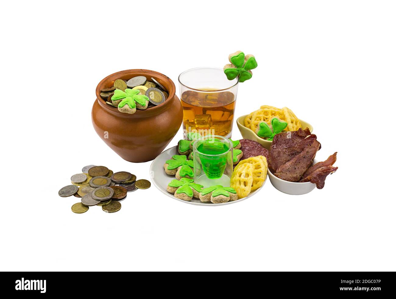 Clay pot with coins clover meat snack stack of green liquor a glass of scotch whiskey with ice. Patr Stock Photo