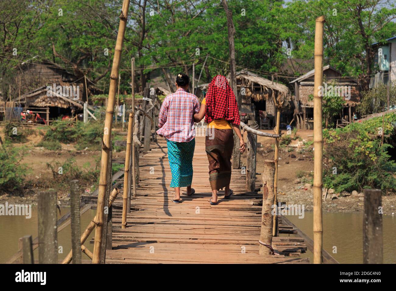 Two women on a wooden bridge in Myanmar Stock Photo - Alamy