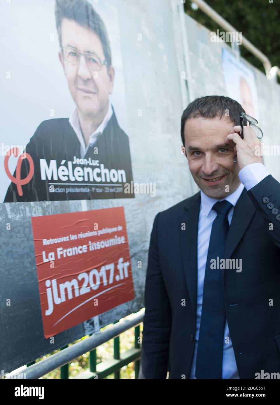 Presidential election candidate for the left-wing French Socialist (PS) party Benoit Hamon poses by a poster of his electoral campaign (with Melenchon) during a visit at the Cerisaie-Derriere-Les-Murs neighbourhood under renovation, in Villiers-le-Bel, on April 12, 2017. Photo by Eliot Blondet/ABACAPRESS.COM Stock Photo