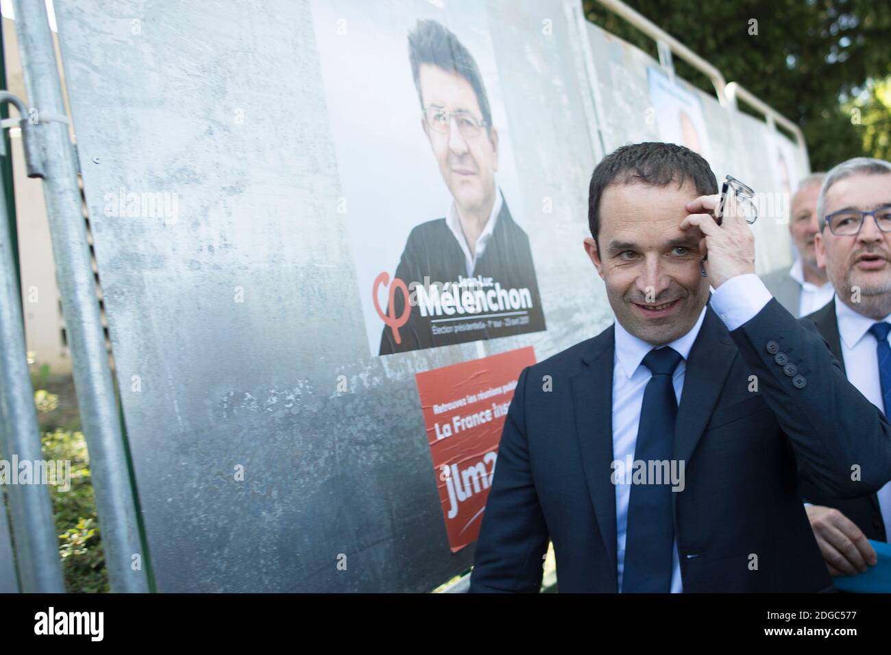 Presidential election candidate for the left-wing French Socialist (PS) party Benoit Hamon poses by a poster of his electoral campaign (with Melenchon) during a visit at the Cerisaie-Derriere-Les-Murs neighbourhood under renovation, in Villiers-le-Bel, on April 12, 2017. Photo by Eliot Blondet/ABACAPRESS.COM Stock Photo