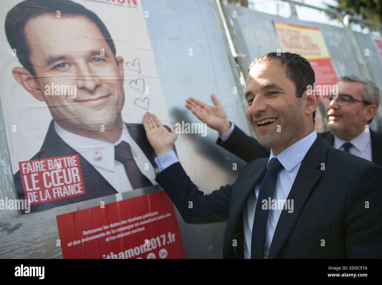 Presidential election candidate for the left-wing French Socialist (PS) party Benoit Hamon poses by a poster of his electoral campaign during a visit at the Cerisaie-Derriere-Les-Murs neighbourhood under renovation, in Villiers-le-Bel, on April 12, 2017. Photo by Eliot Blondet/ABACAPRESS.COM Stock Photo