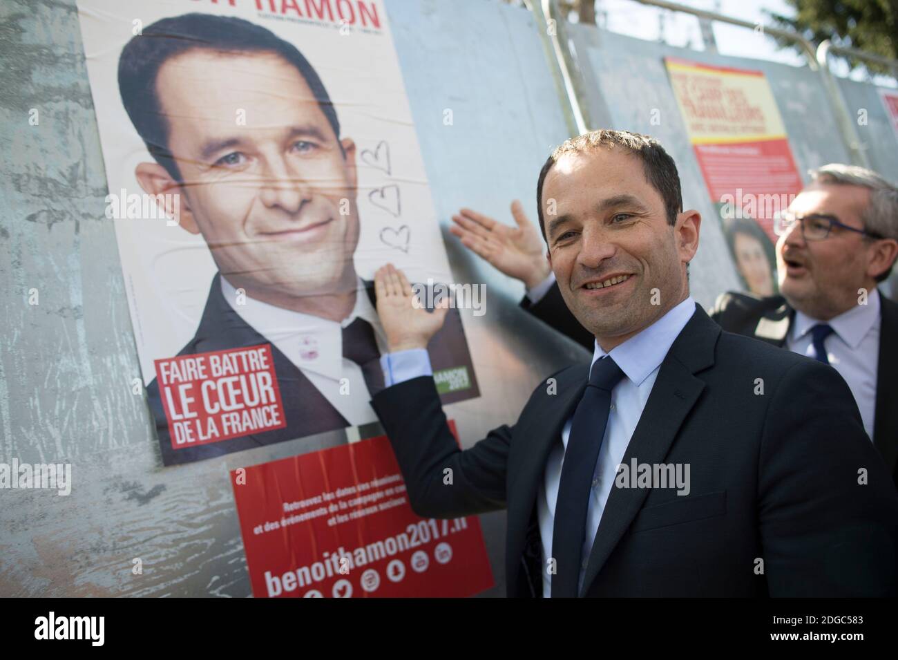 Presidential election candidate for the left-wing French Socialist (PS) party Benoit Hamon poses by a poster of his electoral campaign during a visit at the Cerisaie-Derriere-Les-Murs neighbourhood under renovation, in Villiers-le-Bel, on April 12, 2017. Photo by Eliot Blondet/ABACAPRESS.COM Stock Photo