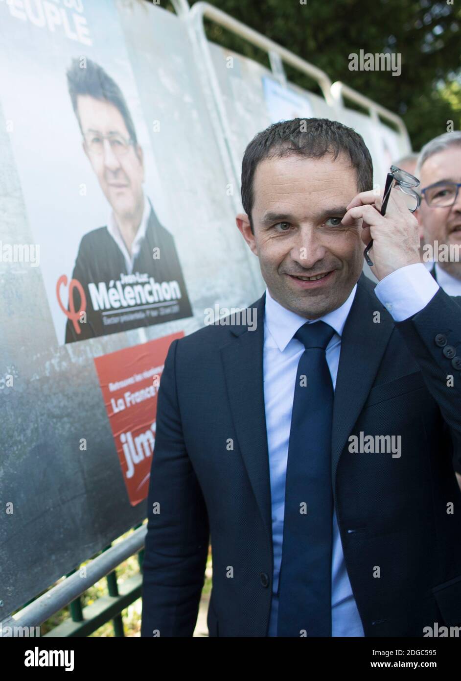 Presidential election candidate for the left-wing French Socialist (PS) party Benoit Hamon poses by a poster of his electoral campaign (with Melenchon) during a visit at the Cerisaie-Derriere-Les-Murs neighbourhood under renovation, in Villiers-le-Bel, on April 12, 2017. Photo by Eliot Blondet/ABACAPRESS.COM Stock Photo