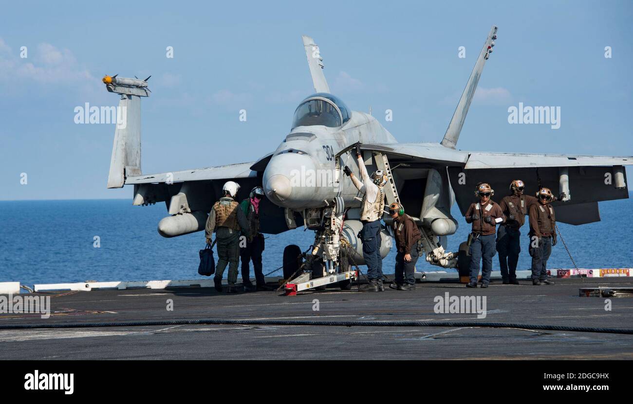 Handout photo - SOUTH CHINA SEA (April 12, 2017) Sailors perform a preflight check on an F/A-18E Super Hornet from the Strike Fighter Squadron (VFA) 192 “Golden Dragons” on the aircraft carrier USS Carl Vinson (CVN 70) flight deck. Allegedly ordered to hurry to North Korea as a show of force to deter despot Kim Jong-un from testing a nuclear weapon, the U.S. Navy Third Fleet’s Carl Vinson Carrier Strike Group instead ended up near Australia last week, nearly 4,900 miles away from where it was officially supposed to be. The Navy confirmed Tuesday that it didn’t send one of its aircraft carriers Stock Photo