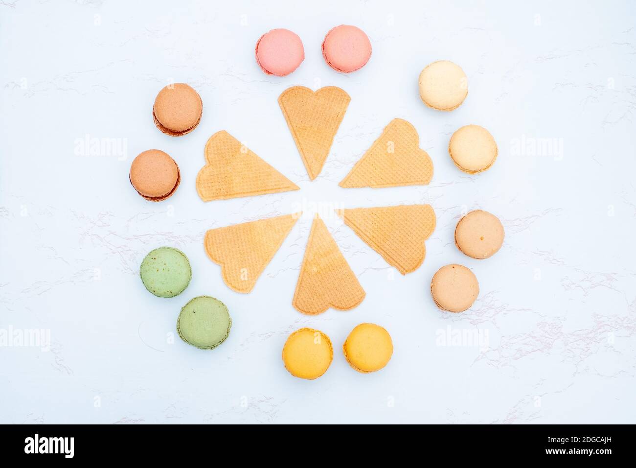 Fun flat lay composition of macarons and a cookie Stock Photo - Alamy