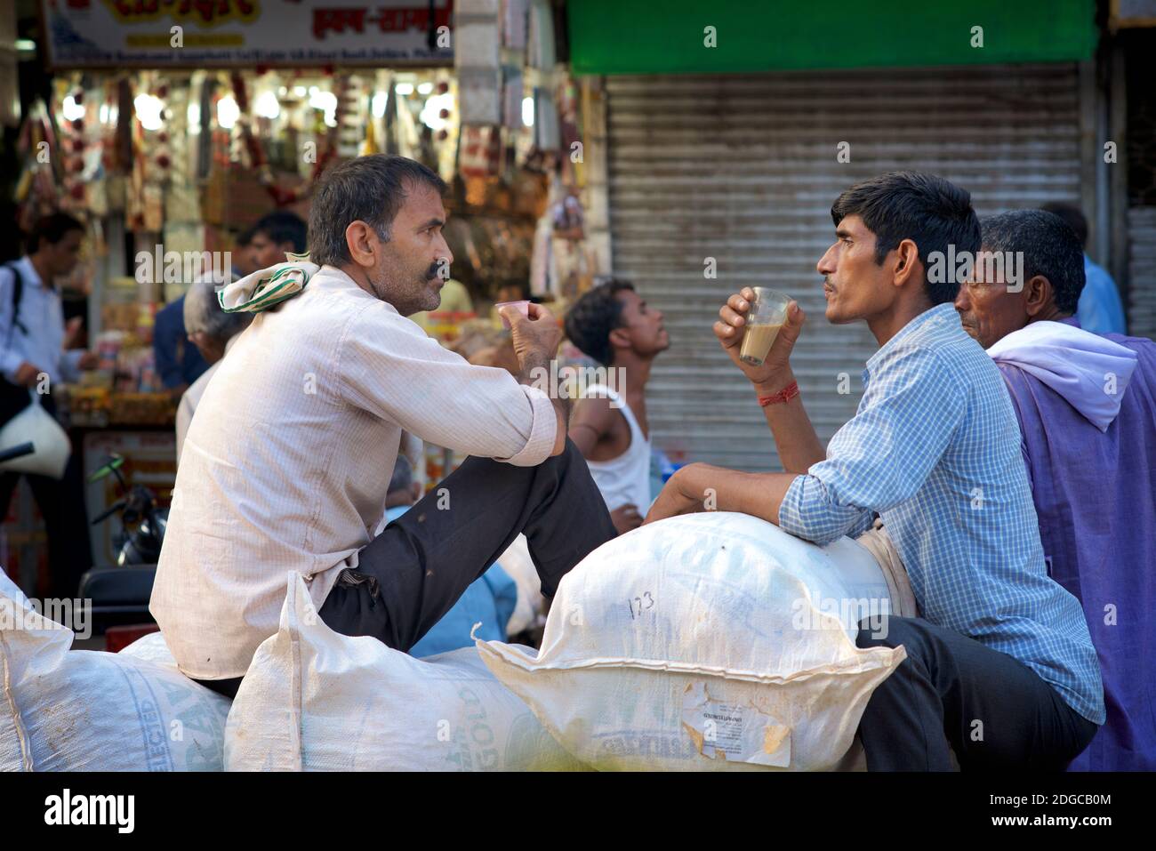Indian market traders drinking tea together, Chandi Chowk market area