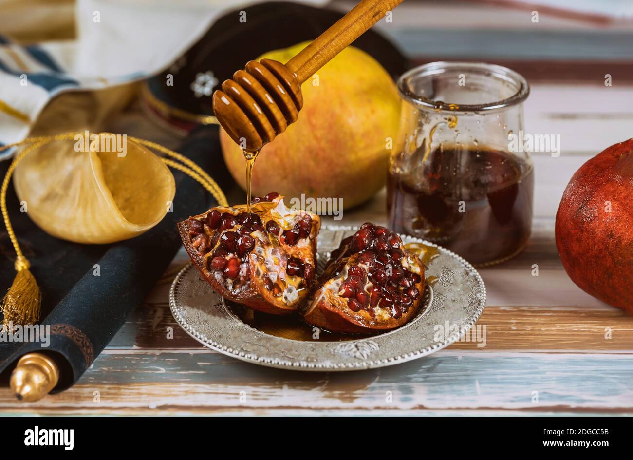 Apple, pomegranate and honey of jewish New Year Rosh Hashana torah book, kippah yamolka talit Stock Photo