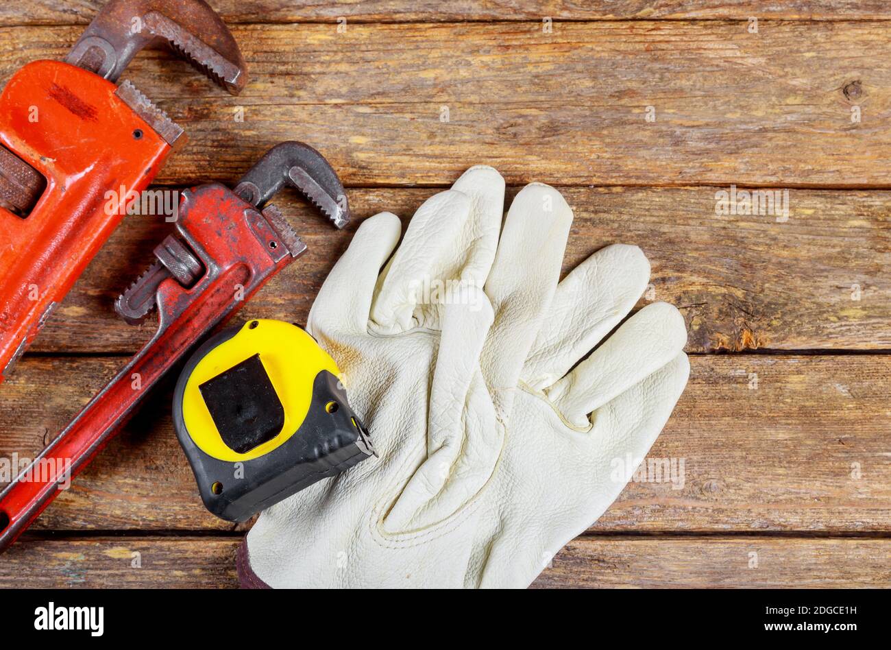 Wrench plumbing leather safety gloves construction concept. Stock Photo