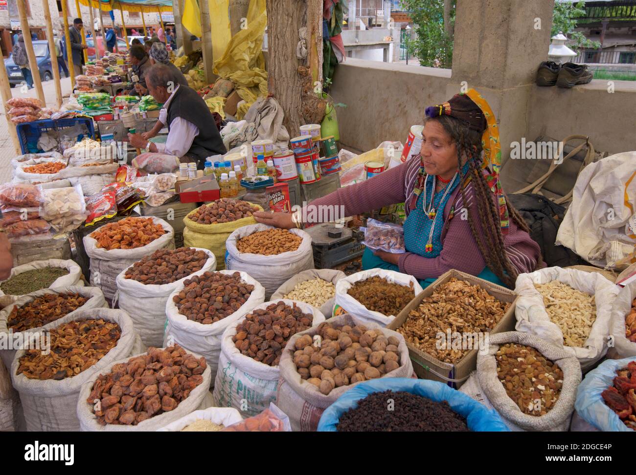 Friendly Ladakhi market vendor selling nuts from his stall. Leh, Ladakh, Jammu and Kashmir, India Stock Photo