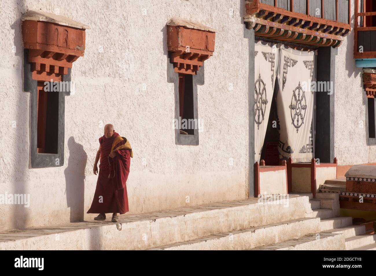 Early morning at Hemis monastery. A monk heading to the prayer hall. Hemis, Ladakh, Jammu and Kashmir, India Stock Photo