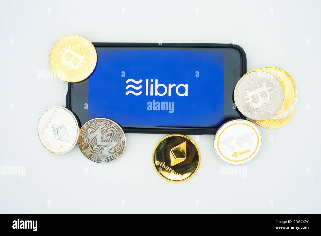 Facebook Libra is a new crypto currency. The photo of smartphone with  Facebook logo on tge screen and the Libra logo on the broshure next to it  Stock Photo - Alamy