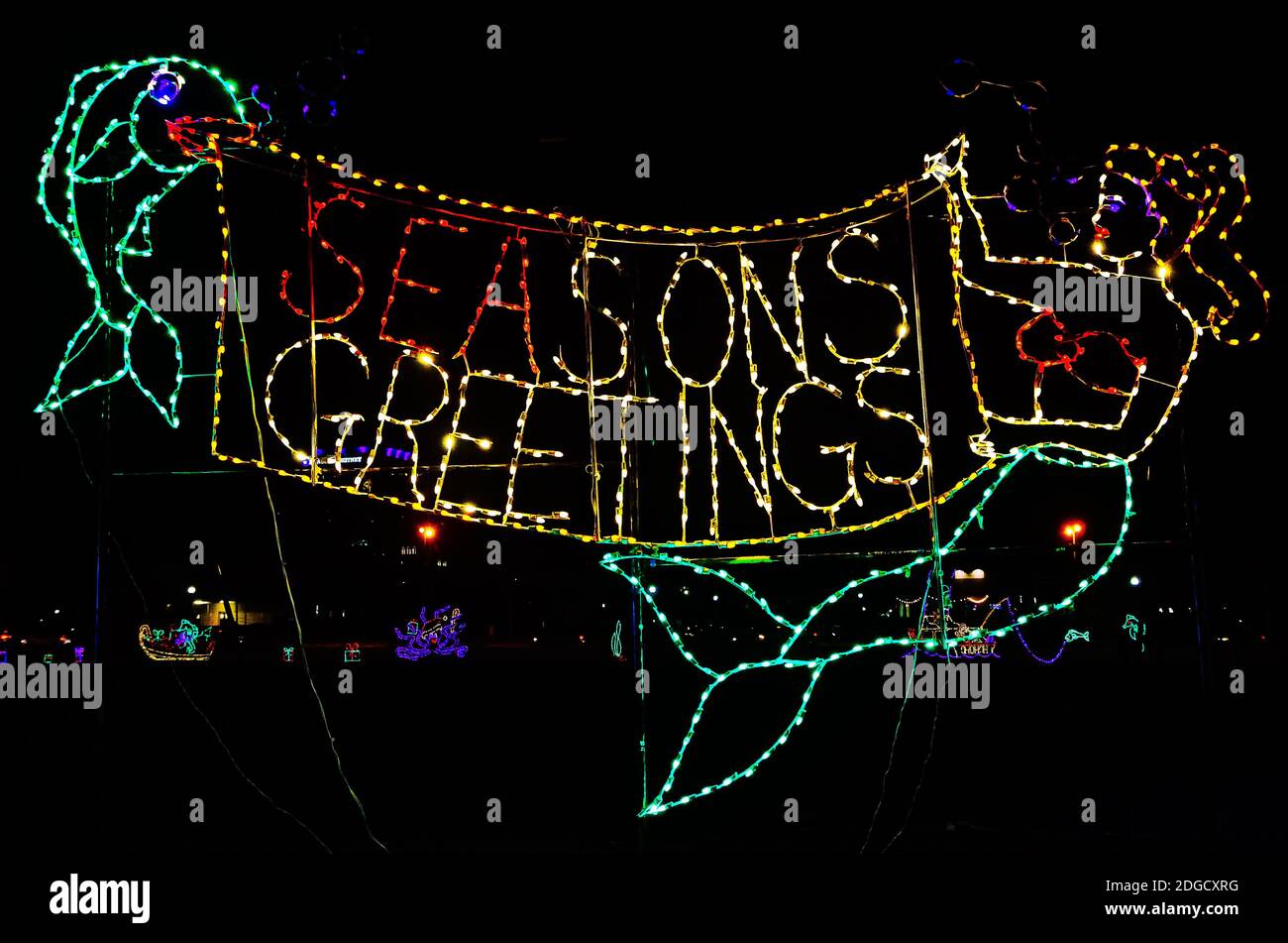 Christmas lights spell Season's Greetings and depict a nautical scene