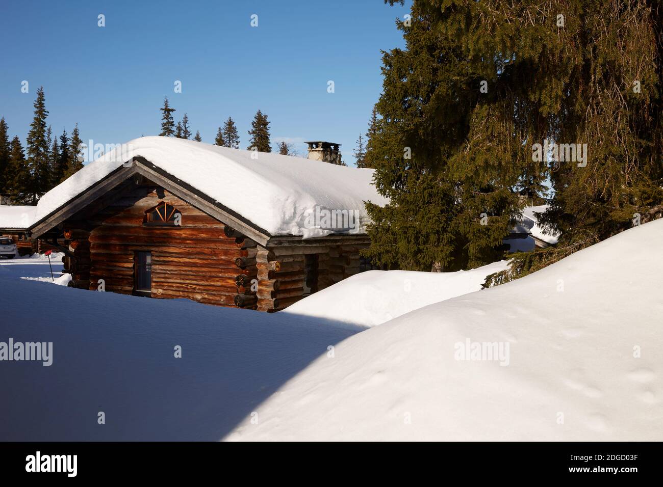 Snowy Log Cabin in the Sun in Lapland Stock Photo - Alamy