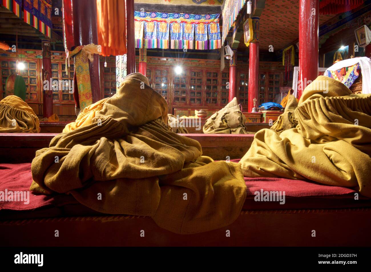 Monastic robes in the prayer hall at Likir monastery, Likir, Ladakh, Jammu and Kashmir, India Stock Photo