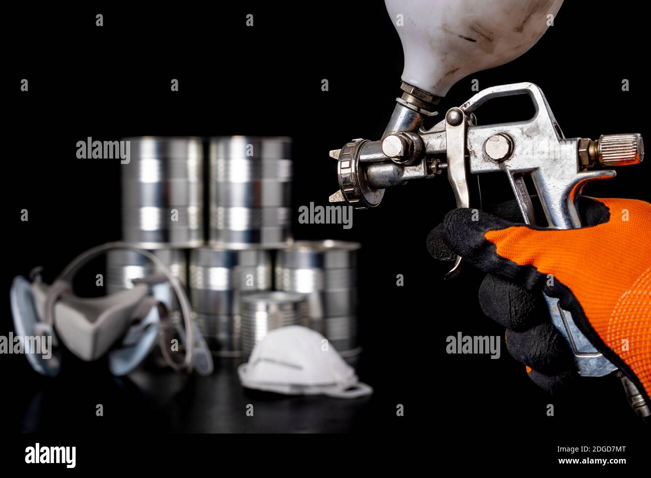 Metal spray gun for painting in a paint shop. Accessories for painting work  in a home workshop. Dark background Stock Photo - Alamy