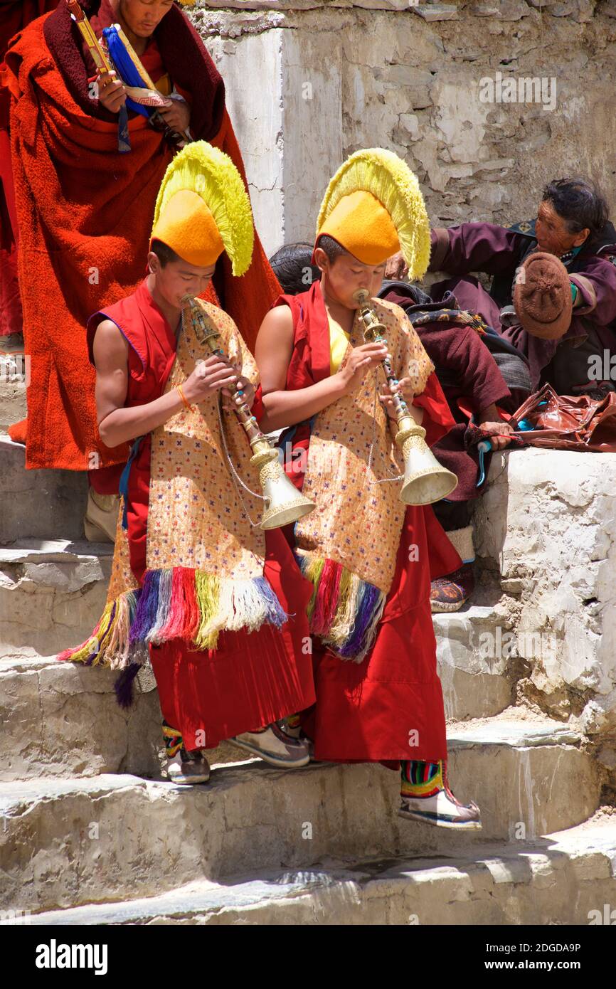 Yellow hat monks wearing yellow tsoksha hats and blowing Tibetan trumpets, Karsha Gustor festival, Karsha monastery, near Padum Zanskar Valley, Ladakh, Jammu and Kashmir, northern India Stock Photo