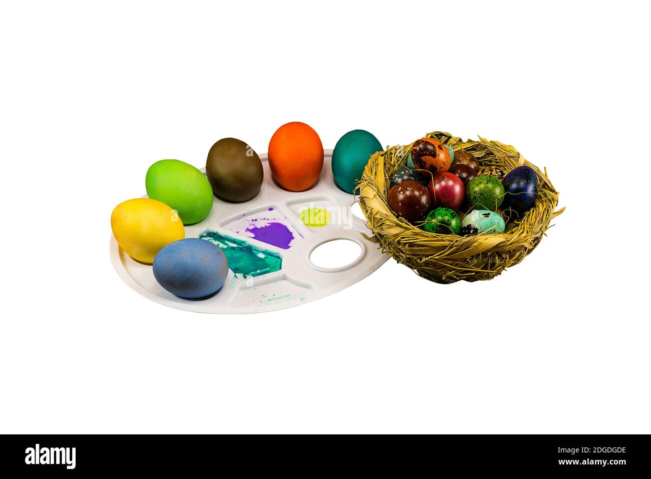 Painted eggs with a straw nest on a white background, celebration of Easter Stock Photo