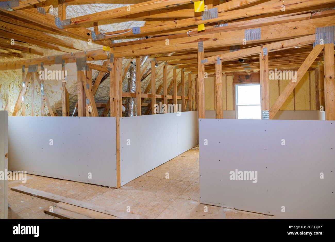 Inside attic roof andwall insulation in wooden house, building under construction Stock Photo