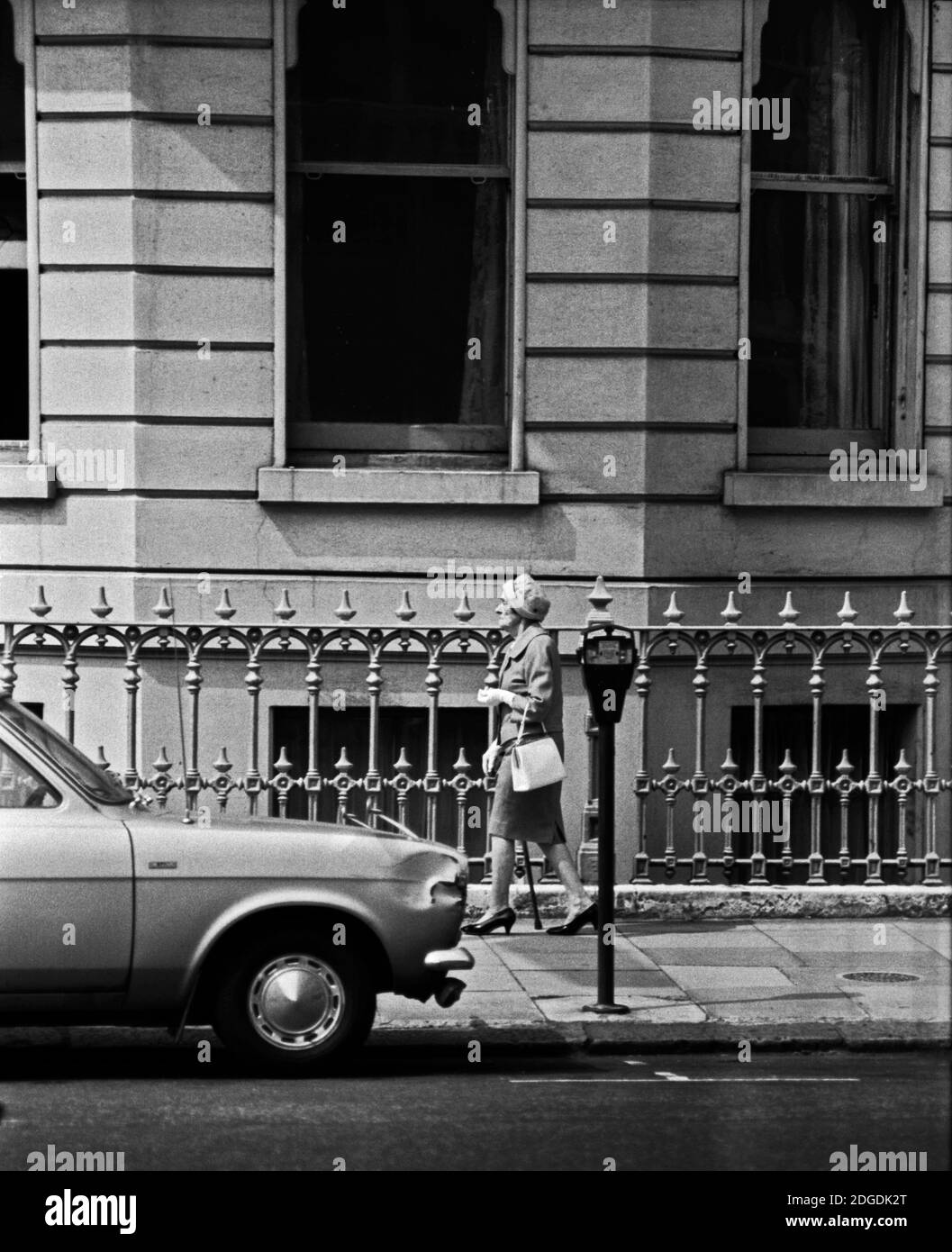 An elderly woman walks down the street. London, 1971 Stock Photo