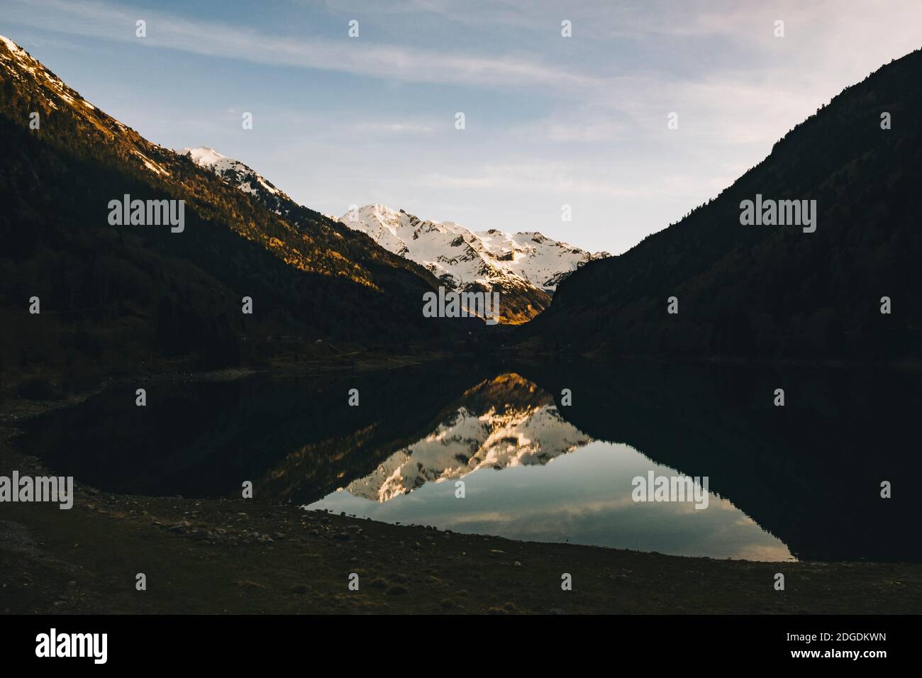 Pyrenees snowcapped mountains peaks reflected in the Lac de Fabrges, Laruns, France Stock Photo