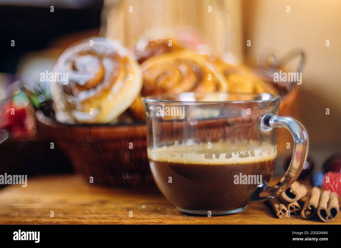 Cinnamon rolls with coffee on wooden table Stock Photo