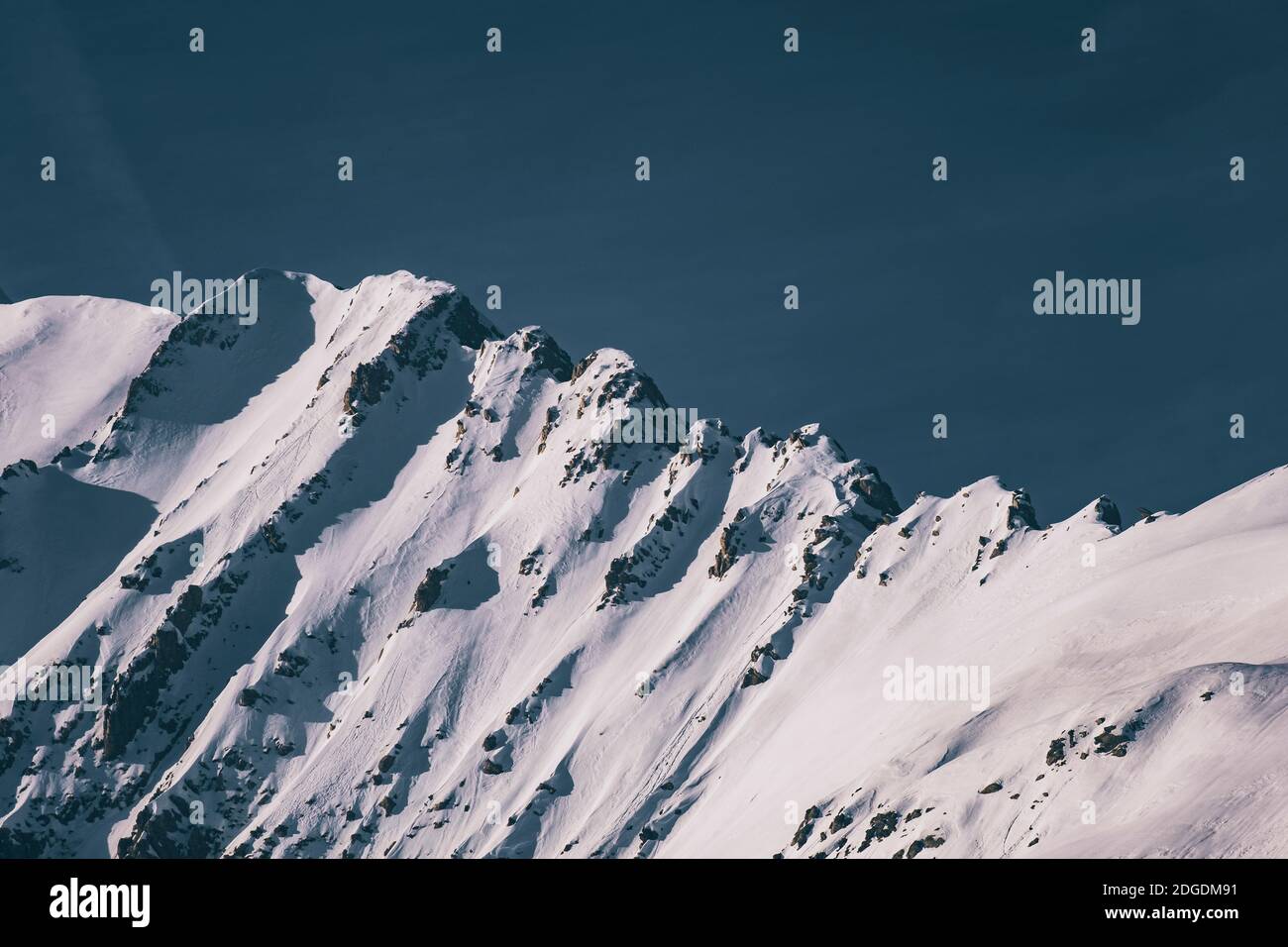 Scenic view of snowcapped mountains against hazy sky, Panticosa, Huesca, Spain Stock Photo