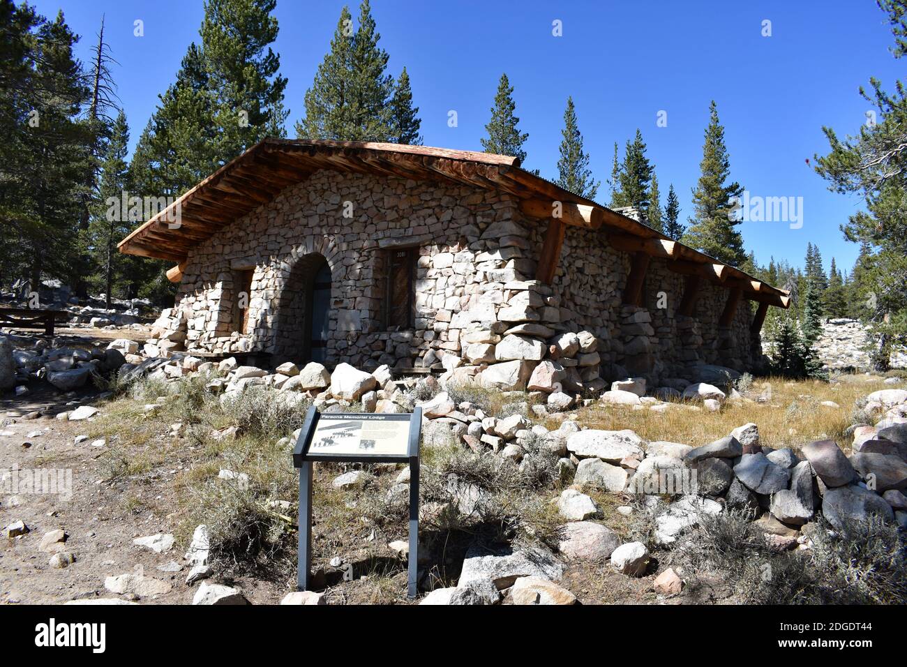 Parsons Lodge, A stone and wooden hut structure in Tuolumne Meadows, Yosemite National Park, USA. A sign with information for visitors stands outside. Stock Photo