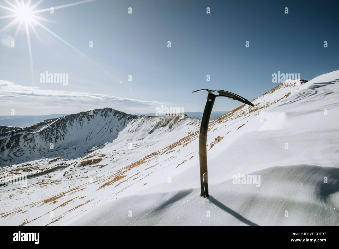 Mountaineering ice ax on snow slope near summit of Wheeler Peak, NM Stock Photo