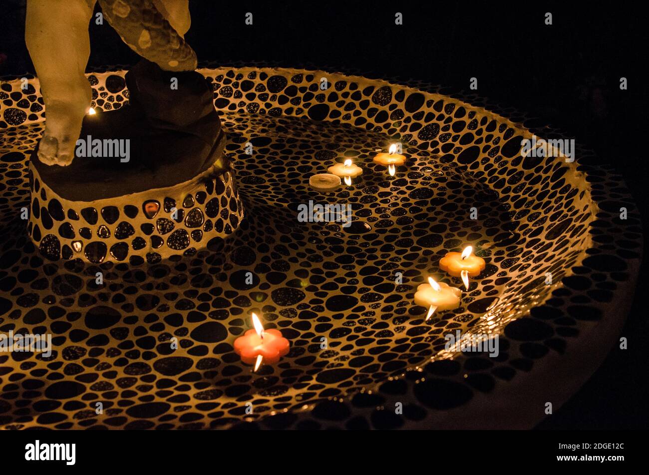 floating candles in small fountain at night Stock Photo Alamy