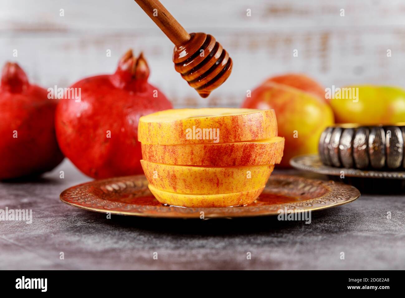 Honey on the pomegranate and apples. Jewish new year Rosh Ha Shana Stock Photo