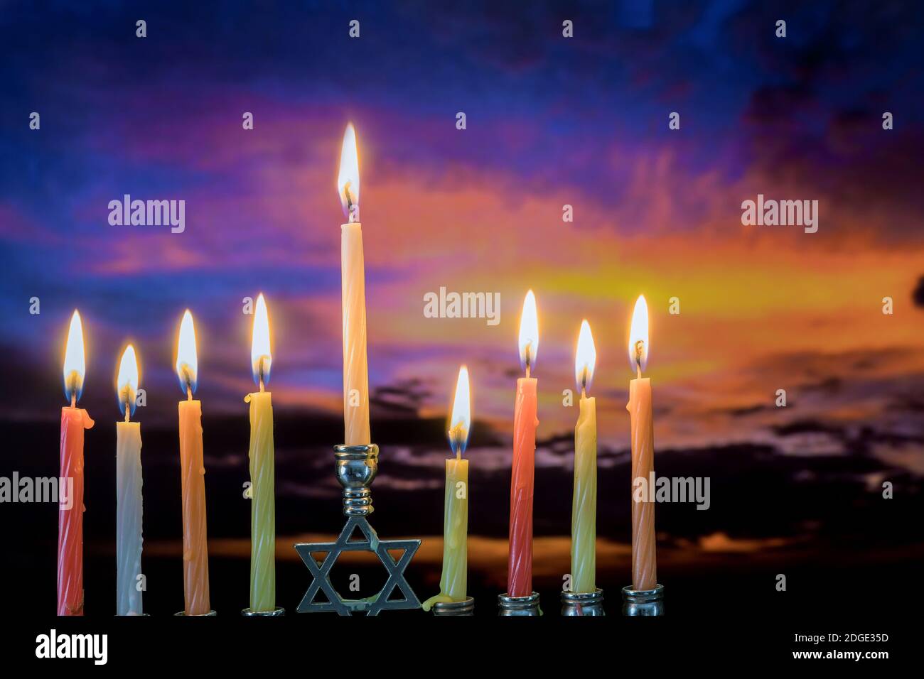 Jewish holiday symbol Hanukkah menorah sunset sky clouds Stock Photo